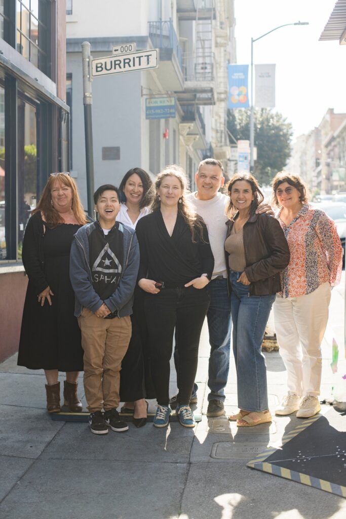 Group portrait of Savor The Light workshop attendees with Cyntia Apps, San Francisco Bay Area culinary photographer, at Bouche SF during a natural light food photography workshop.