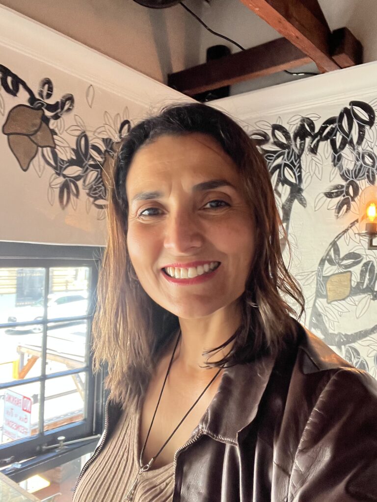 Cyntia Apps, San Francisco Bay Area culinary photographer and founder of Savor The Light, smiling during her natural light food photography workshop at Bouche SF.