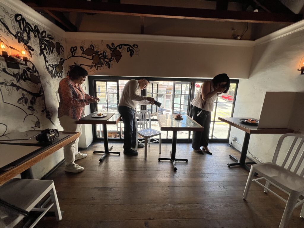 Participants styling plates and photographing vibrant dishes under soft natural light during Savor the Light workshop in San Francisco.
food styling, natural light photography class, San Francisco food photography, hands-on workshop, food creatives